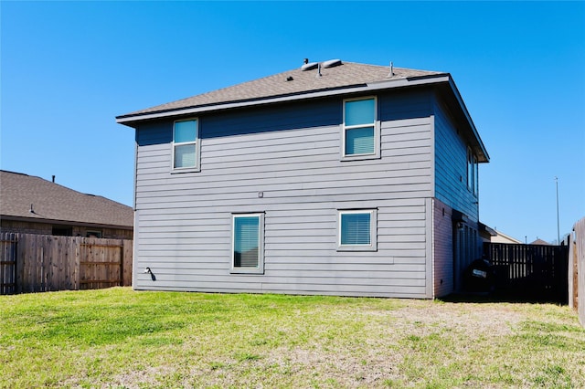 back of property with a yard and a fenced backyard