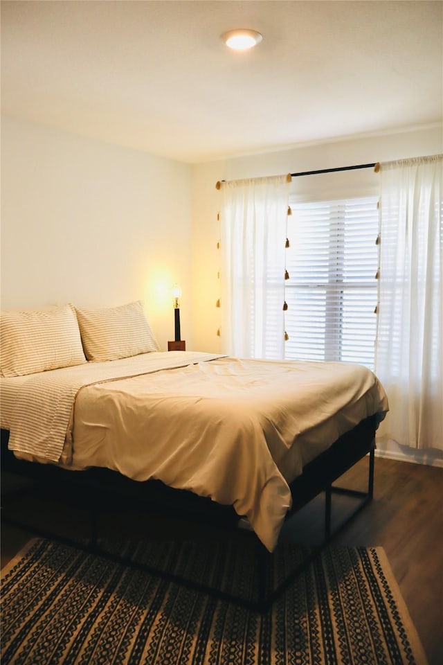 bedroom with dark wood-type flooring