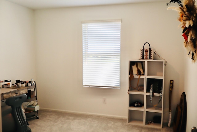 carpeted home office featuring baseboards