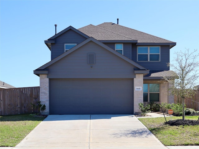 traditional-style house with driveway, a shingled roof, a garage, and fence