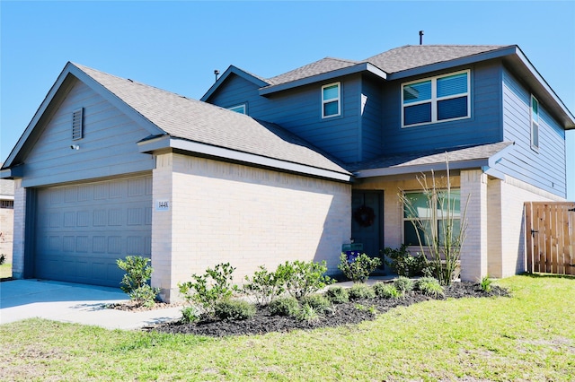 traditional-style home featuring concrete driveway, a front lawn, brick siding, a garage, and fence