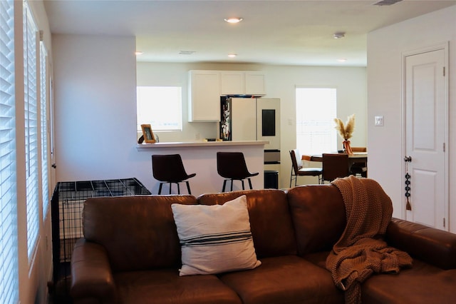 living room featuring plenty of natural light, recessed lighting, and visible vents