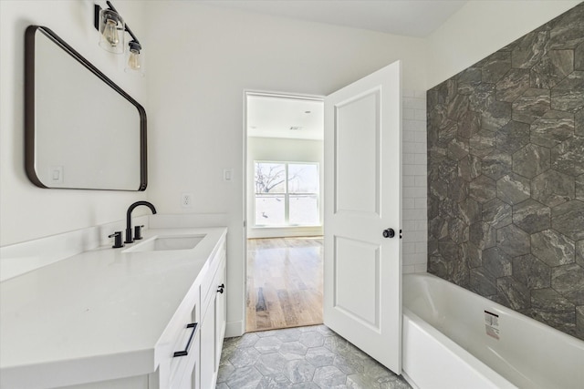 bathroom featuring washtub / shower combination and vanity