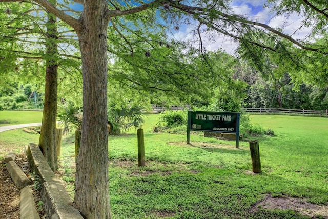 surrounding community with a lawn and fence