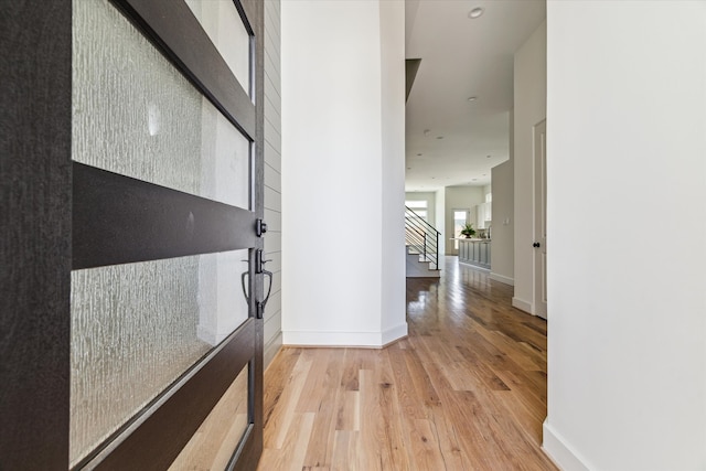 entryway featuring stairway, recessed lighting, light wood-type flooring, and baseboards