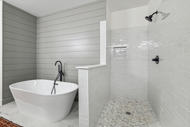 full bathroom featuring a soaking tub and tiled shower