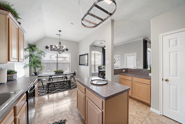 kitchen featuring light brown cabinets, dark countertops, arched walkways, dishwasher, and vaulted ceiling