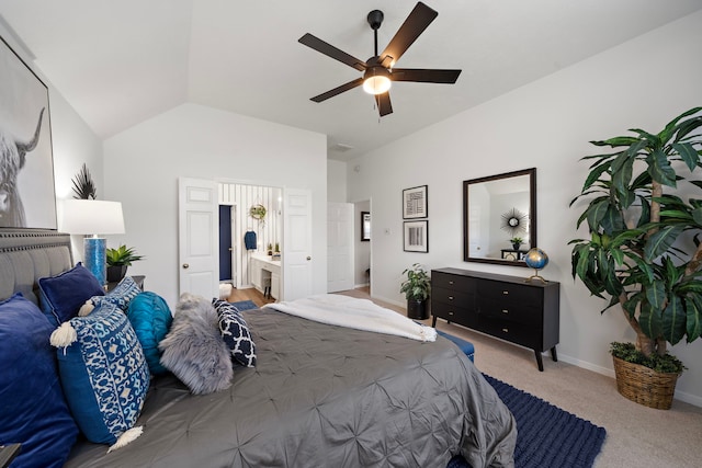 carpeted bedroom featuring ceiling fan, baseboards, connected bathroom, and lofted ceiling