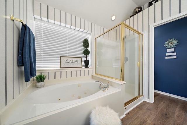 full bathroom featuring wood finished floors, baseboards, wallpapered walls, a shower stall, and a jetted tub