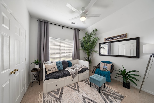 sitting room featuring visible vents, a ceiling fan, carpet flooring, baseboards, and vaulted ceiling