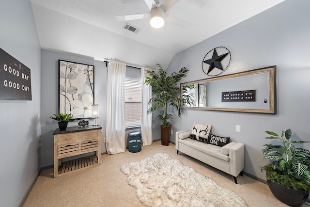 sitting room featuring visible vents, a ceiling fan, baseboards, carpet flooring, and lofted ceiling