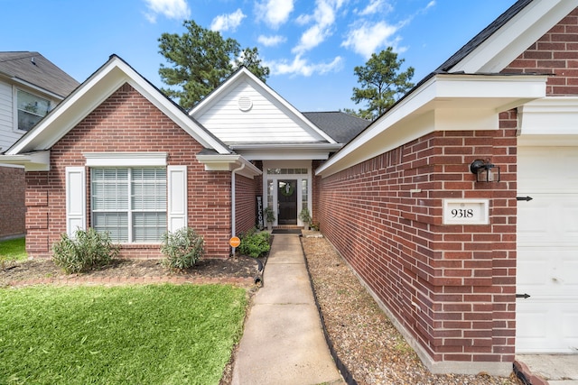 property entrance with brick siding and an attached garage