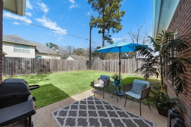 view of patio with a grill and a fenced backyard