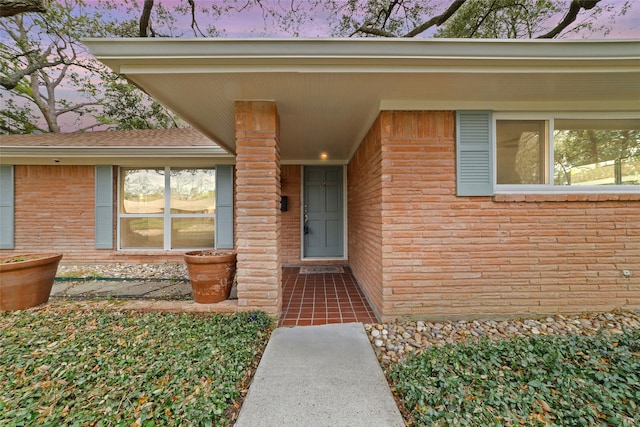 property entrance with brick siding