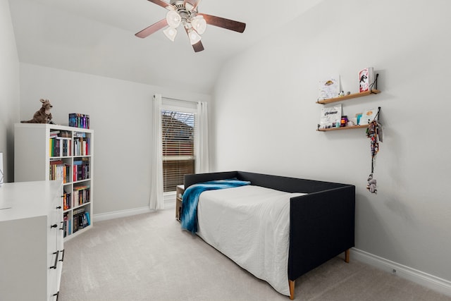 carpeted bedroom with baseboards, a ceiling fan, and vaulted ceiling