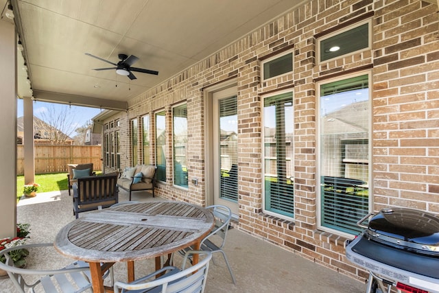 view of patio / terrace featuring a grill, ceiling fan, and fence