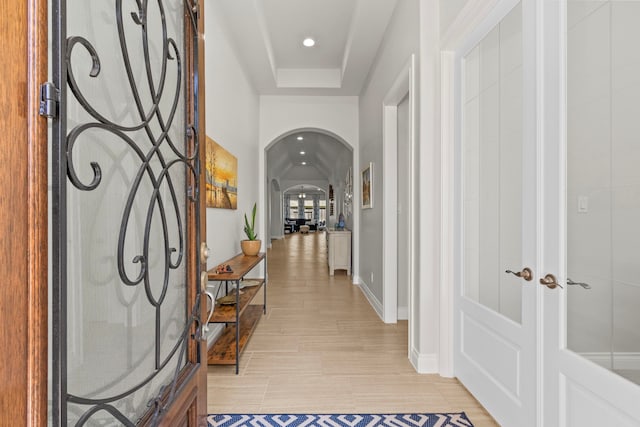 entryway with recessed lighting, baseboards, arched walkways, and french doors