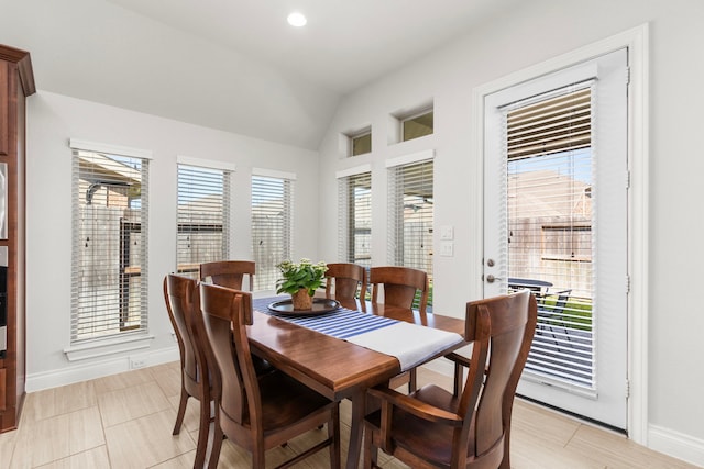 dining space featuring lofted ceiling, recessed lighting, and baseboards