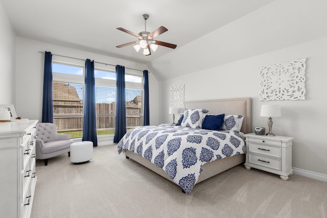 bedroom with vaulted ceiling, a ceiling fan, baseboards, and light carpet