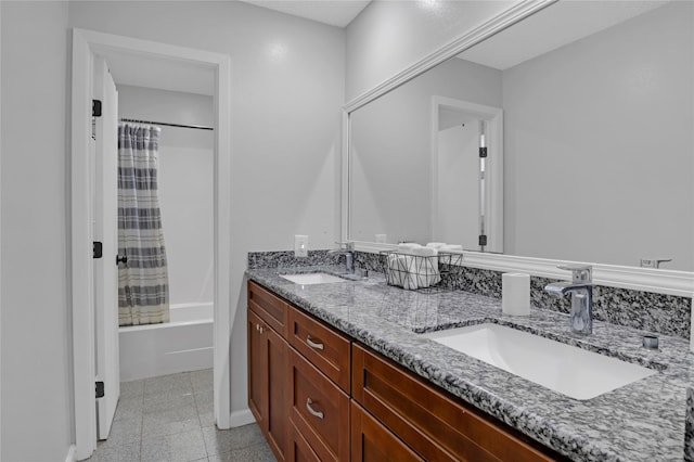 full bathroom featuring granite finish floor, shower / bath combination with curtain, double vanity, and a sink