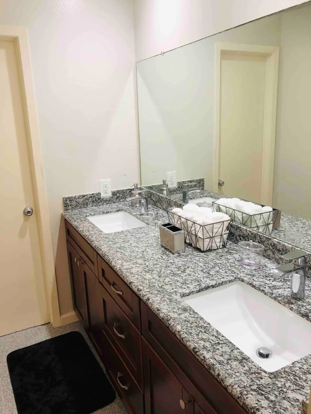 bathroom with double vanity and a sink