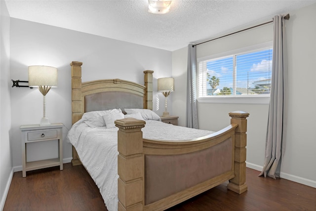 bedroom featuring dark wood-type flooring, baseboards, and a textured ceiling