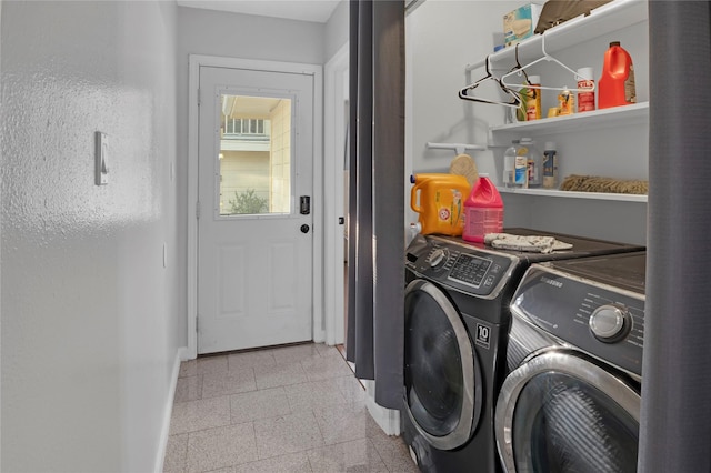 laundry area featuring laundry area, granite finish floor, baseboards, and washing machine and clothes dryer