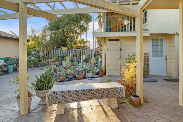 view of patio / terrace featuring a balcony and fence