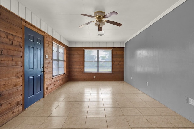 unfurnished room with light tile patterned floors, visible vents, ceiling fan, and ornamental molding