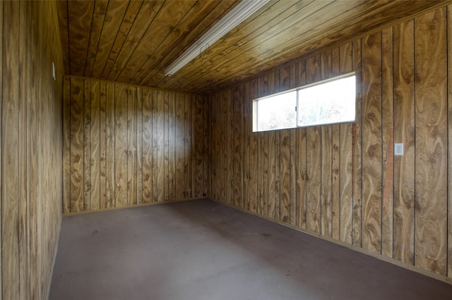 empty room featuring wooden ceiling, wooden walls, and a sauna