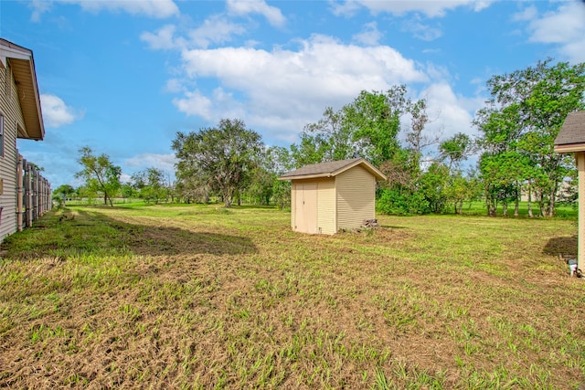 view of yard featuring an outbuilding and a storage shed