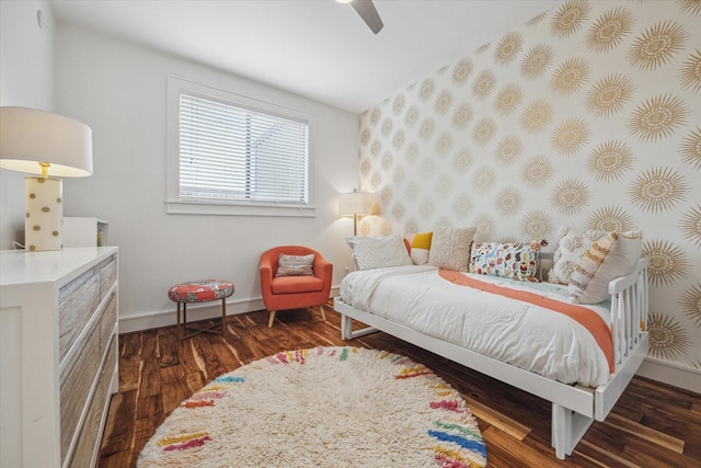 bedroom with baseboards, wood finished floors, and a ceiling fan