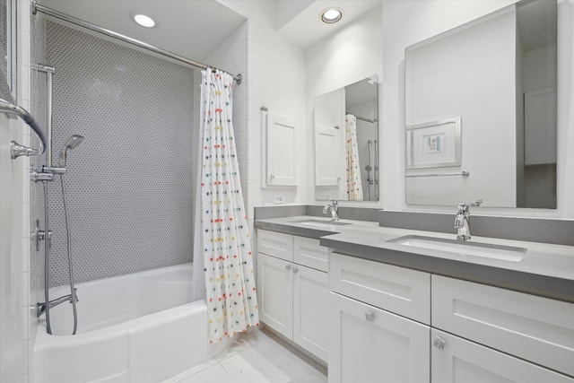 full bathroom featuring tile patterned flooring, double vanity, shower / bath combo with shower curtain, and a sink