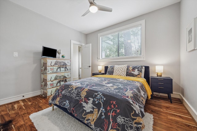 bedroom with baseboards, wood finished floors, and a ceiling fan