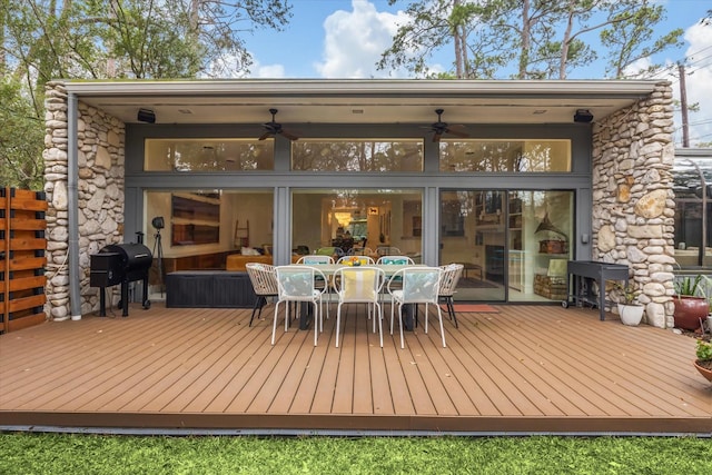 wooden terrace with outdoor dining space and area for grilling