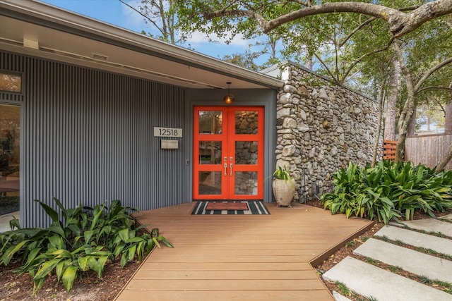 doorway to property with stone siding and french doors