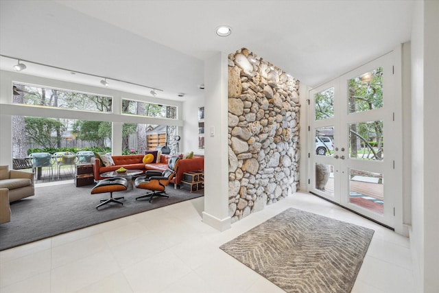 interior space featuring tile patterned floors, french doors, and rail lighting