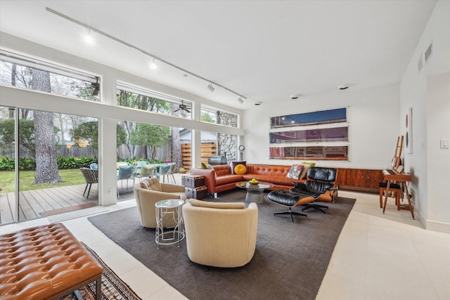 living room featuring tile patterned flooring and a healthy amount of sunlight