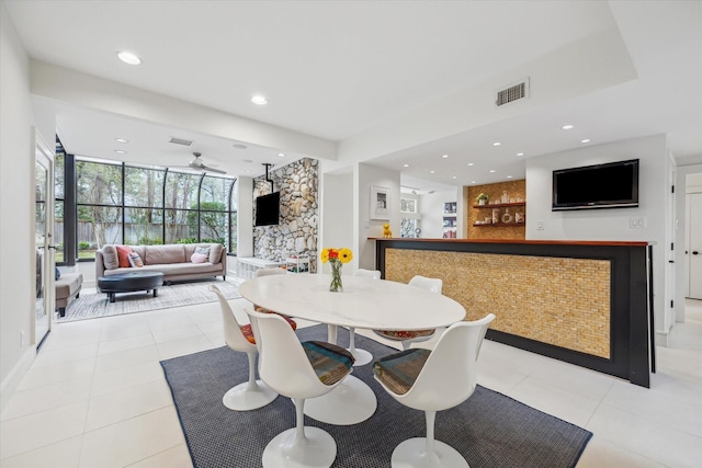 dining room featuring a bar, light tile patterned flooring, recessed lighting, and visible vents