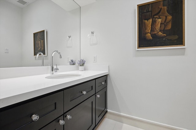 bathroom featuring vanity, baseboards, and visible vents