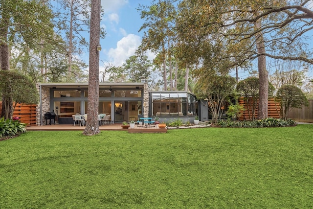 back of house featuring a ceiling fan, a yard, fence, and a wooden deck