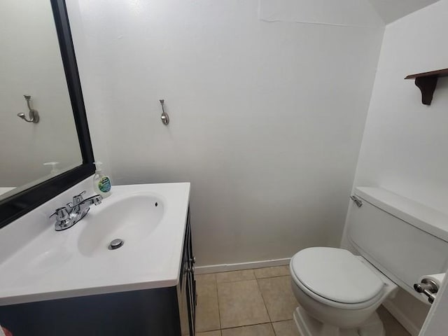 bathroom with vanity, tile patterned floors, toilet, and baseboards