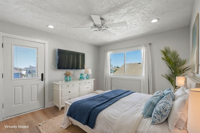 bedroom with light wood finished floors, recessed lighting, a textured ceiling, and a ceiling fan