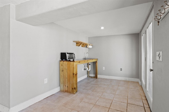 interior space with light tile patterned floors, recessed lighting, and baseboards