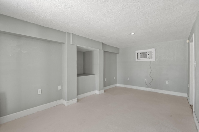 finished below grade area with a textured ceiling and baseboards