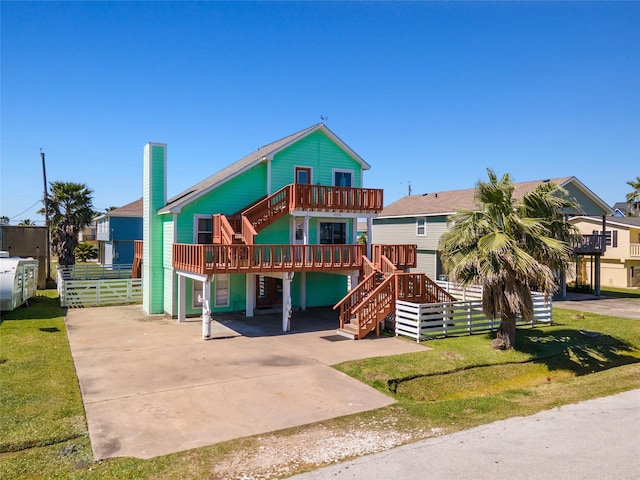 coastal home with a front lawn and stairs