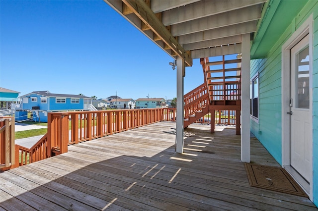 deck with stairway and a residential view