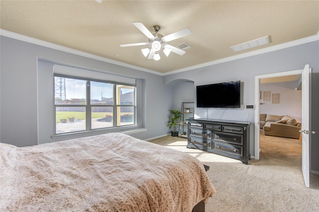 bedroom with crown molding, arched walkways, visible vents, and carpet floors