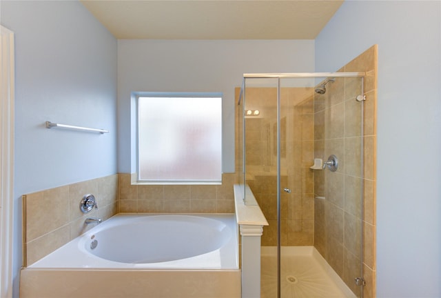 bathroom featuring a bath and a stall shower