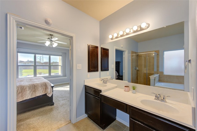 bathroom with a shower stall, double vanity, tile patterned floors, and a sink